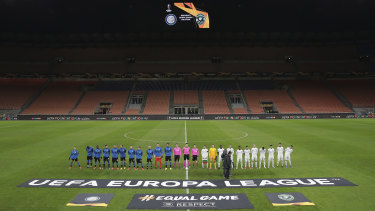 Inter Milan and Ludogorets line up inside the empty San Siro stadium ahead of their Europa League round-of-32 match.