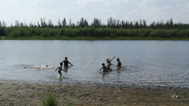 Children play in the Krugloe lake outside Verkhoyansk - the Siberian town that endures the world's widest temperature range, which has recorded a new high amid a heatwave that is contributing to severe forest fires. 