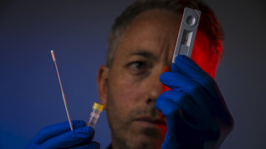 Peter Walsh with one of the rapid diagnostic tests, which he hopes will roll out in aged care facilities.