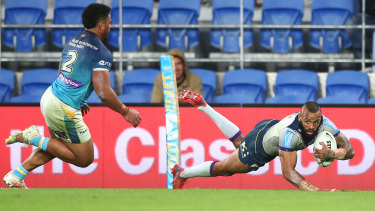 Josh Addo-Carr crosses out wide as the Storm surged home in the second half against the Titans.