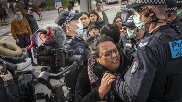 People were arrested at a small business anti-lockdown protest outside Flinders Street Station on Saturday.
