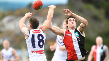 Jack Sinclair of the Saints and Darcy Tucker of the Dockers compete for the ball.