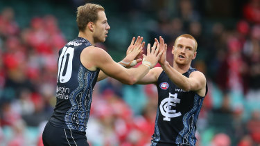 Harry McKay of the Blues celebrates kicking a goal.