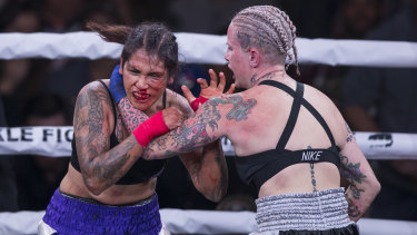 Gloves off: Alma Garcia, left, takes a hit from Bec Rawlings during their 125-pound bout.