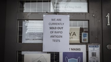 A sign posted to the door of a pharmacy in Melbourne informs customers it has sold out of rapid antigen tests.