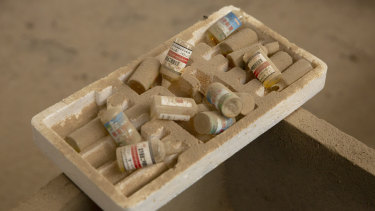 Vials of inoculations sit on a feeder trough in the barn barn of a pig farmer  in northern China's Hebei Province. 