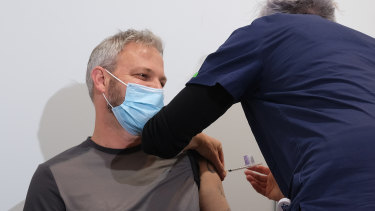 Victoriaâ€™s Chief Health Officer Brett Sutton gets his AstraZeneca needle at the Royal Exhibition Centre.