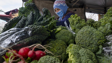 Sophia Stasey selling vegetables at the Bendigo Farmers Market. 