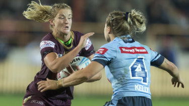 Queensland's Meg Ward is tackled by NSW's Isabelle Kelly during last year's Women's State of Origin match.