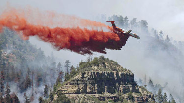 An aircraft drops fire retardant on the fire in the mountains near Durango, Colorado. Fires in the south-west of the state continue to burn largely out of control. 