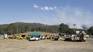 Fire and emergency crews from NSW prepare to join their Queensland counterparts in the ongoing bushfire control effort near the rural town of Canungra.