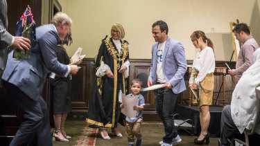 Naga Pandri and his son Srithan (centre) with lord mayor Sally Capp during the citizenship ceremony at Melbourne Town Hall on Saturday.