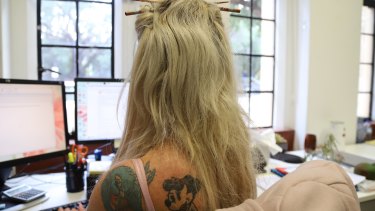Tattoos are becoming more acceptable in the workplace, new research suggests.