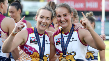 Lauren Arnell (left) with premiership teammate Breanna Koenen after the 2021 grand final in Adelaide.