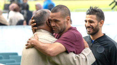 Australian boxer Anthony Mundine, in red, joins Muslims for the call to pray at Hagley Park, opposite the Al Noor mosque, in Christchurch, New Zealand, on Friday.