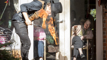 Fire performer Chris James and resident Maggie Goller during the window show at Lifeview's aged care home The Willows.
