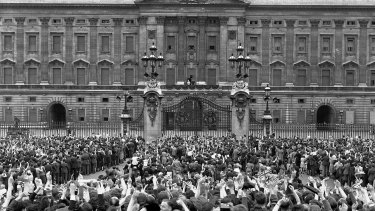 A vast crowd assembles in front of Buckingham Palace, London to cheer Britain's Royal family as they come out on the balcony, centre, minutes after the official announcement of Germany's unconditional surrender in World War II on May 8, 1945. 