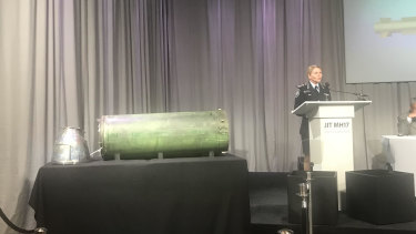 AFP commander Jennifer Hurst shows the missile that allegedly shot down MH17 at a press conference in the Netherlands.