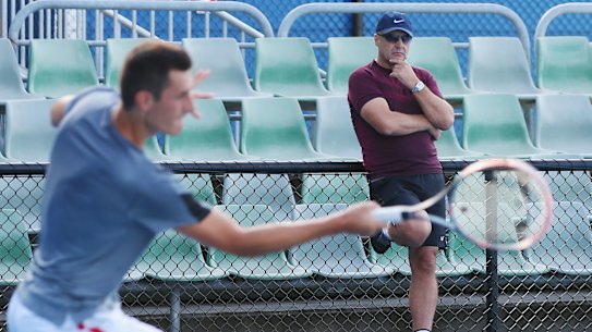 John Tomic watches on as his son Bernard trains during the 2016 Australian Open.
