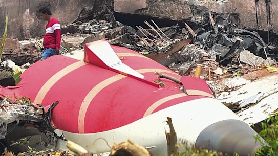 Investigative officials stand at the site of Air India Boeing 787 that crashed  on June 13. 