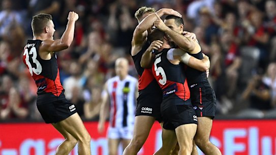MELBOURNE, AUSTRALIA - APRIL 03: Alec Waterman of the Bombers is congratulated by team mates after kicking a goal during the round 3 AFL match between the Essendon Bombers and the St Kilda Saints at Marvel Stadium on April 03, 2021 in Melbourne, Australia. (Photo by Quinn Rooney/Getty Images)