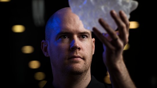Bureau of Meteorology thunderstorm research scientist Dr Joshua Soderholm with a 3D replica of the world’s largest hailstone.