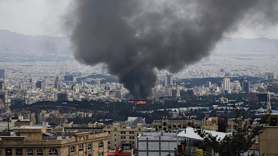 Smoke rises after a reported Israeli strike on a building used by Islamic Republic of Iran News Network, part of Iran’s state TV broadcaster.
