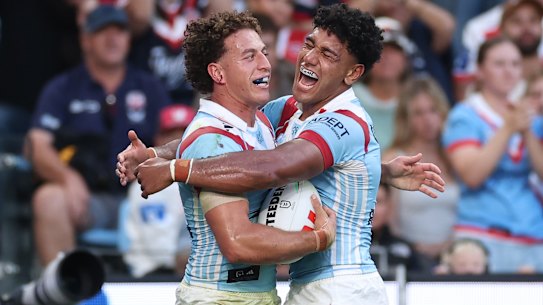 Mark Nawaqanitawase and Siua Wong celebrate a Roosters try on Anzac Day.