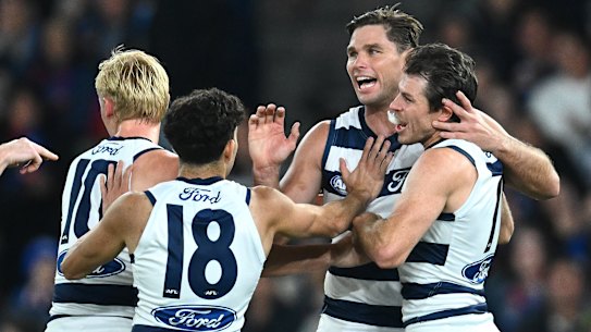 Geelong players celebrate.