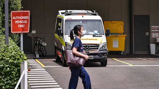 Public health worker walk past the ambulances parked in the emergency bay at St Vincent’s Hospital in Darlinghurst, Sydney on Jan 12, 2022. Generic of covid.  Photo: Flavio Brancaleone/The Sydney Morning Herald  Photo: Flavio Brancaleone/The Sydney Morning Herald