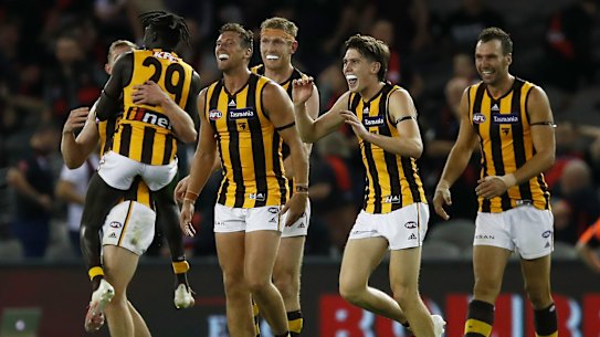 MELBOURNE, AUSTRALIA - MARCH 20: Hawks players celebrate after winning the round one AFL match between the Essendon Bombers and the Hawthorn Hawks at Marvel Stadium on March 20, 2021 in Melbourne, Australia. (Photo by Daniel Pockett/Getty Images)