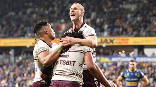 Christian Tuipulotu celebrates with his team mates Tolutau Koula and Daly Cherry-Evans.