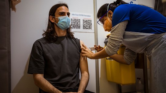 Alex Sartor receiving a Pfizer vaccination at the Melbourne Showgrounds clinic on Wednesday. 