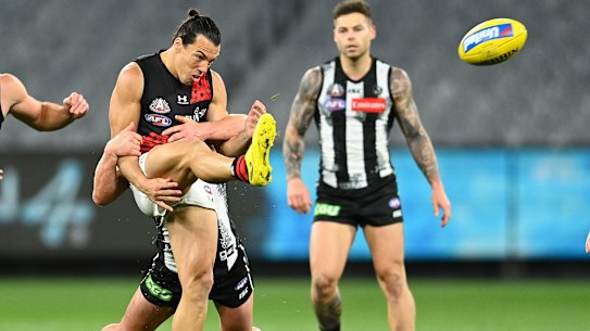 Dylan Shiel of the Bombers gets a kick away against Collingwood on Friday night.