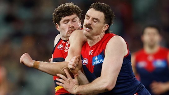 Demon Jake Lever delivers a bump on Adelaide’s Harry Schoenberg last season.