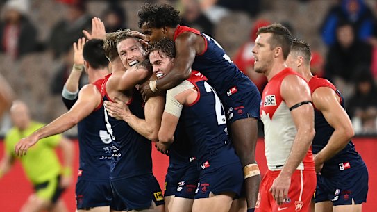 MELBOURNE, AUSTRALIA - MAY 08: Tom McDonald of the Demons is congratulated by team mates after kicking a goal during the round eight AFL match between the Melbourne Demons and the Sydney Swans at Melbourne Cricket Ground on May 08, 2021 in Melbourne, Australia. (Photo by Quinn Rooney/Getty Images)