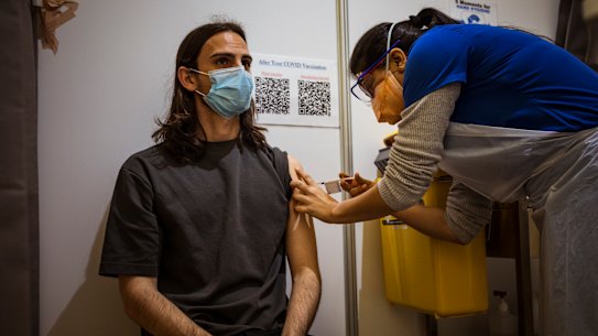 Alex Sartor receiving a Pfizer vaccination at the Melbourne Showgrounds clinic on Wednesday. 
