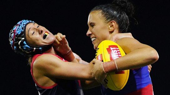 Melbourne's Aliesha Newman tackles Bailey Hunt of the Bulldogs.