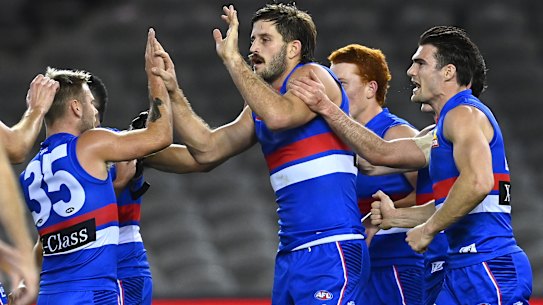 Josh Bruce celebrates with Bulldogs teammates after scoring on Saturday night. 