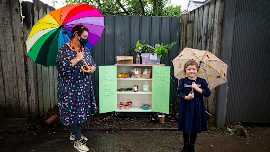 Karan White and her neighbourhood pantry in Hawthorn East, pictured with neighbour Frankie, 4. 