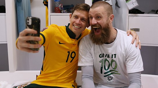 Craig Goodwin and Andrew Redmayne celebrate a famous Socceroos victory.