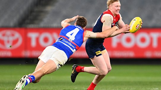 Clayton Oliver is tackled by Marcus Bontempelli.