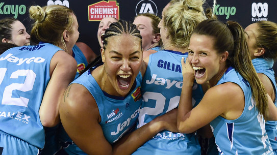 Liz Cambage and the Flyers celebrate their championship triumph.
