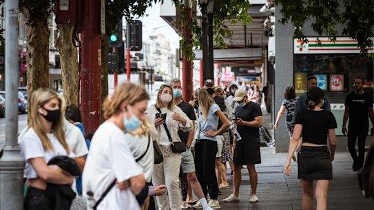 People queue outside the Prahran Town Hall walk-in COVID-19 testing clinic on Monday.