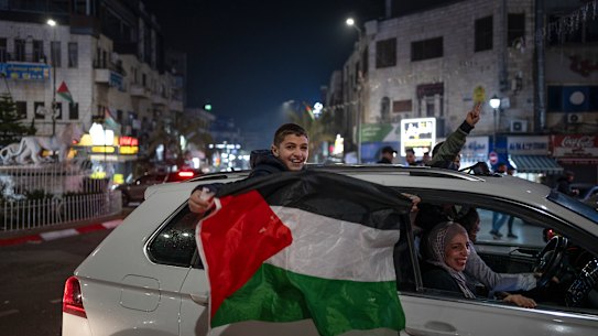 Palestinians in Ramallah in the West Bank celebrate the ceasefire announcement.