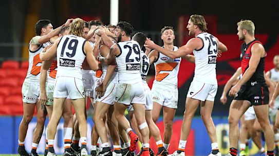 Callan Ward of the Giants is congratulated by team mates after kicking the goal that sealed the match. 