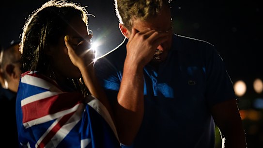 A couple mourns at a candlelight vigil in the days after the attack at Bondi. 
