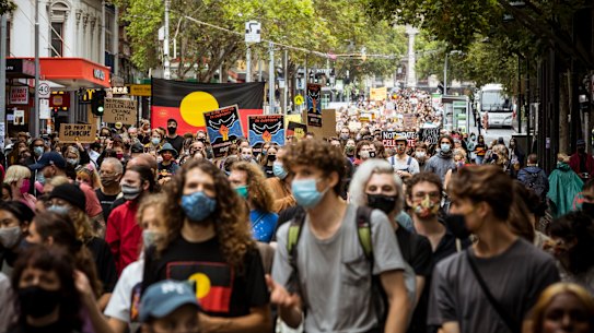Thousands of protesters march through the city on Tuesday.