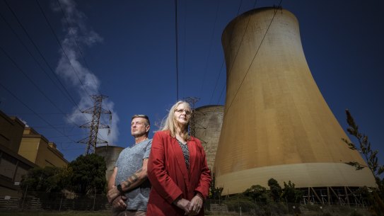 Latrobe Valley residents Wendy Farmer and Tony Wolfe, pictured near the Yallourn Power Plant, advocate for transition away from fossil fuels to renewable energy.