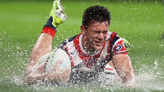Joseph Manu crosses a very wet try line.